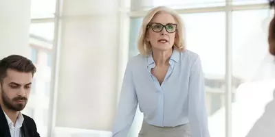 En dame tar ordet i et møte. Foto